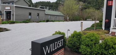 Graded parking lot, spread #8 multi stone and compacted with roller.