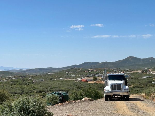 Scenic mountain background while filling a residential water tank