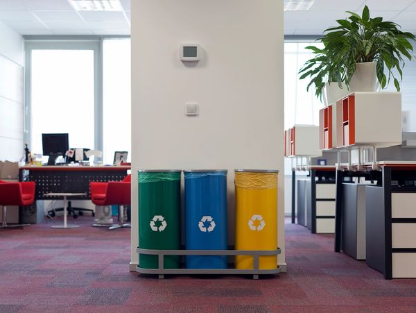 Colorful recycling bins in a modern office space.