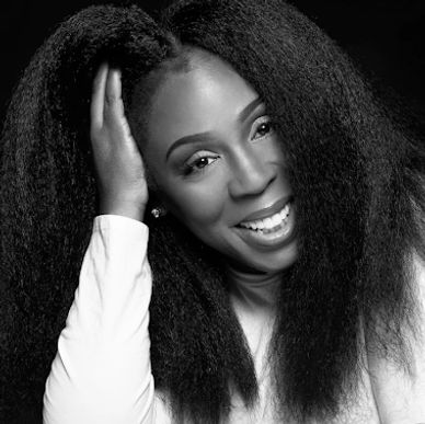 Joyful woman smiling with natural hair.