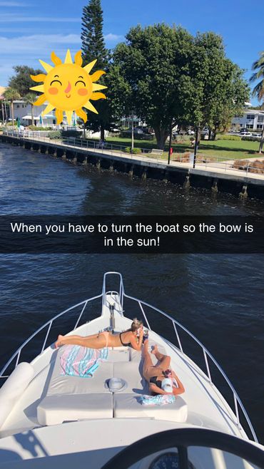family photo relaxing on bow of boat