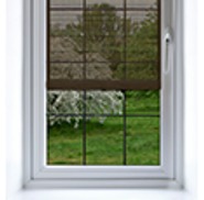 Shade on a window made of semi transparent fabric allowing you to partially see outside the window.