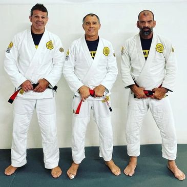 Professor Leandro Massaro with Master Royler Gracie, and Master Megaton Dias