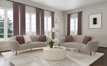 Elegant living room with curved sofas and mauve curtains.