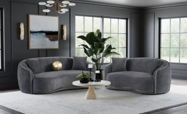 Modern living room with dark gray sofas and large windows.