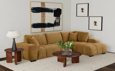 Cozy brown sectional sofa with wooden tables and abstract wall art in a modern living room.