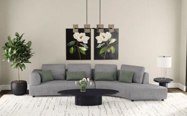 Modern living room with gray sectional sofa, green cushions, floral wall art, and sleek black coffee table.
