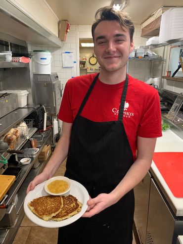 Jamie proudly showing a fresh order of Czapski’s Polish Potato Pancakes.