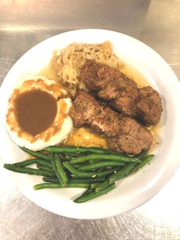 Our famous City Chicken served with mashed potatoes & gravy, kapusta, green beans, bread & butter.