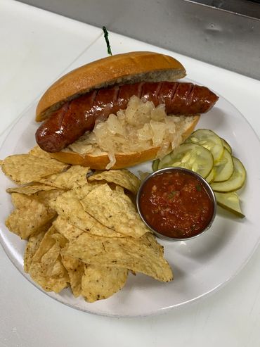 Smoked Kielbasa sandwich with corn chips and our homemade salsa!