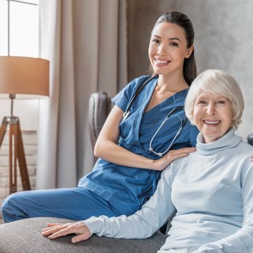 Home Health Care Nurse smiling with her client at home. 
