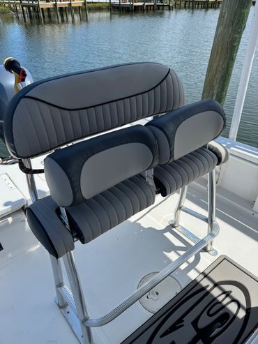 Boat leaning post / helm seat recovered using Sunbrella marine vinyl in a grey/charcoal color schem