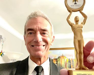 Mike Petrone holding his trophy from The New Jersey Film Awards.