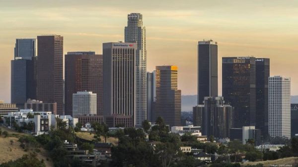 City skyline during sunset with tall buildings.