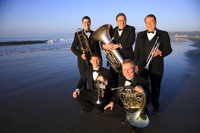 Music concert team standing with instruments at the beach