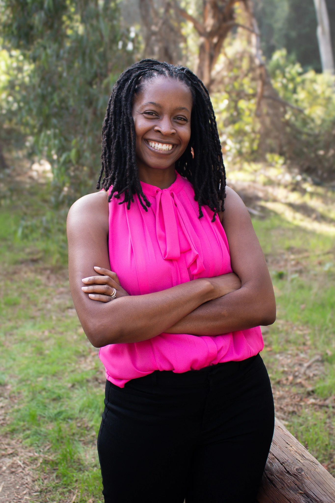 Stack of books next to pencils in a holder and a camera.