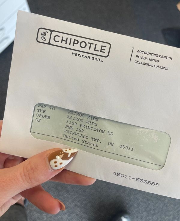 A Chipotle envelope with a check addressed to Kairos Kids.