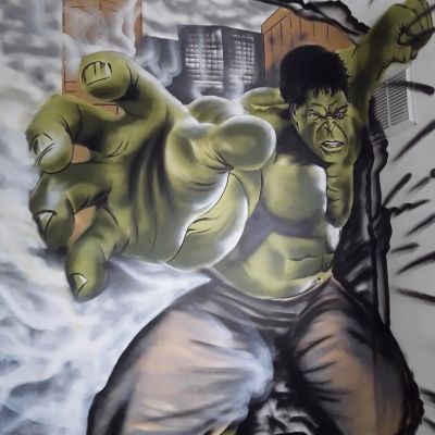 A mural of the Hulk smashing through a wall with an intense expression.