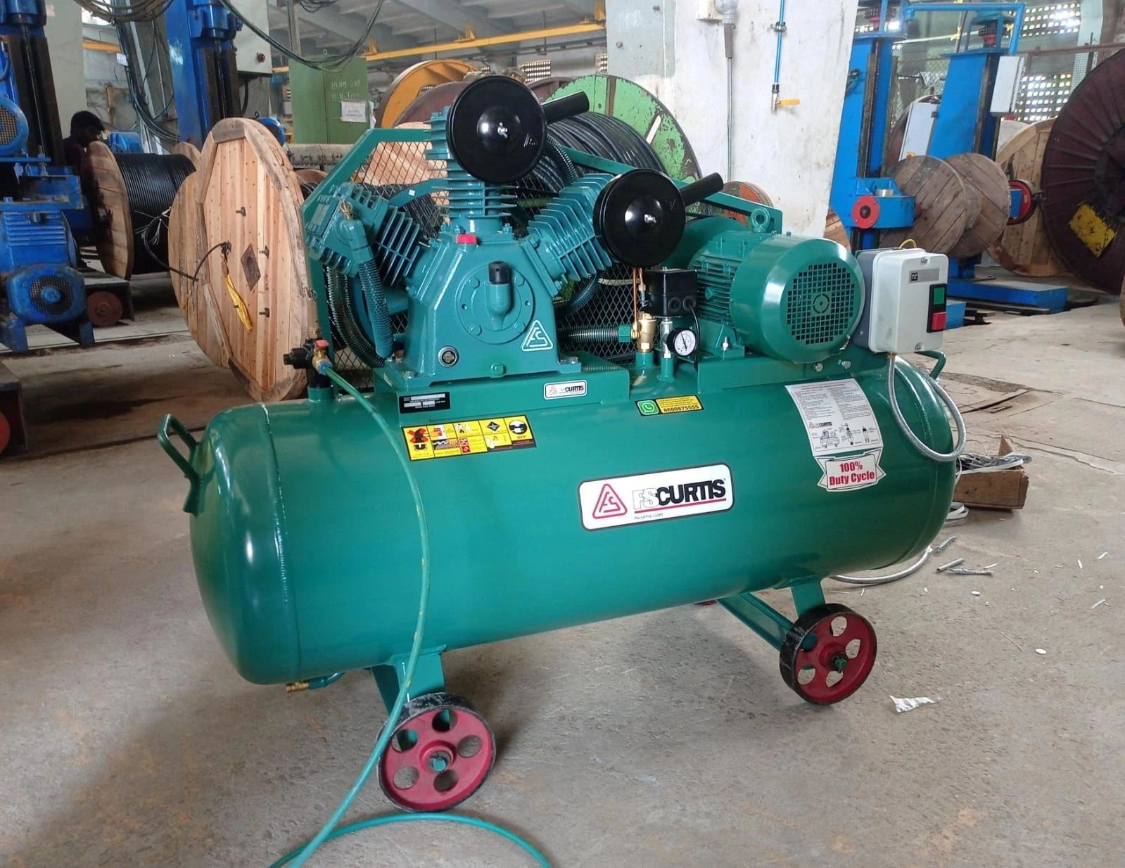 Large industrial air compressor in a workshop setting.