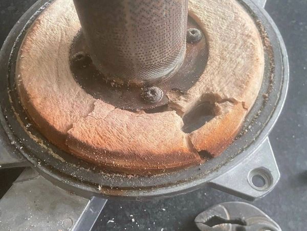 Boiler service showing worn out burner seal and heat exchanger debris