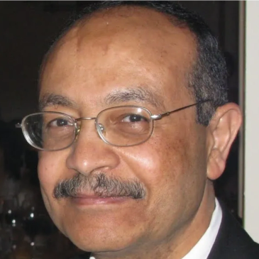 Portrait of a middle-aged man with glasses and a mustache.