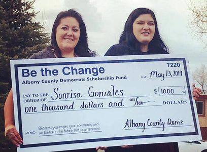 Sonrisa Gonzales (right) with her mother accepting the $1000 scholarship award.