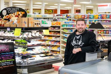 Snow's Family Market employee at grocery counter