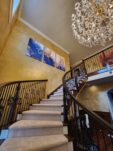 Transform your space with metallic wall finishes, custom artwork, and wood-grained stairs.