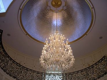 Radiant gilded dome and shimmering walls embraced by elegant wrought iron rails.