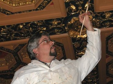 Gold leaf gilding enhances the beauty of the coffered ceiling.
