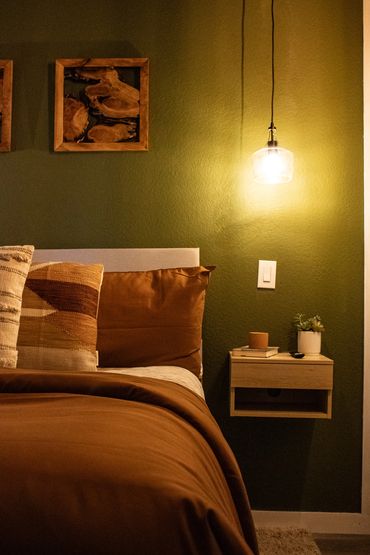 Cozy bedroom corner with warm lighting and earthy tones.