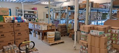 Organized storage room with shelves, boxes, and supplies.