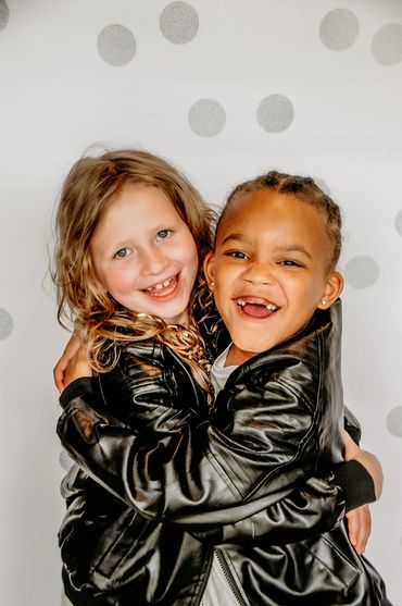 Two GRIT Athletes dancers hugging and smiling