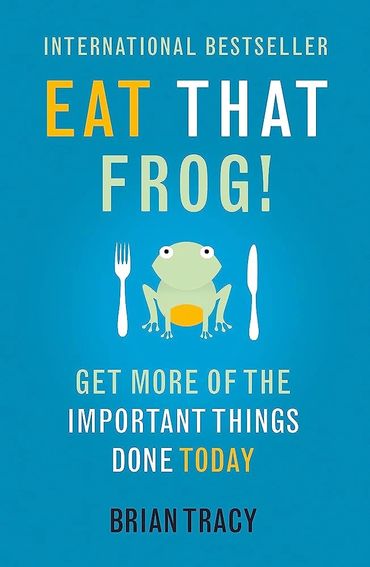 Book cover of "Eat That Frog!" by Brian Tracy with a frog and utensils.