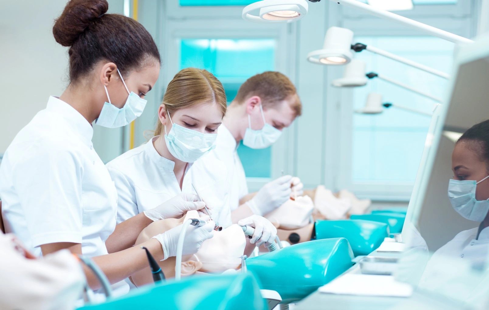 Dental students hands-on practicing.