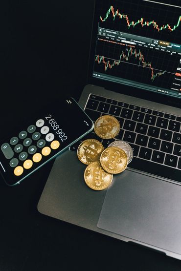 Crypto - Computer & Sell Phone showing investment strategies