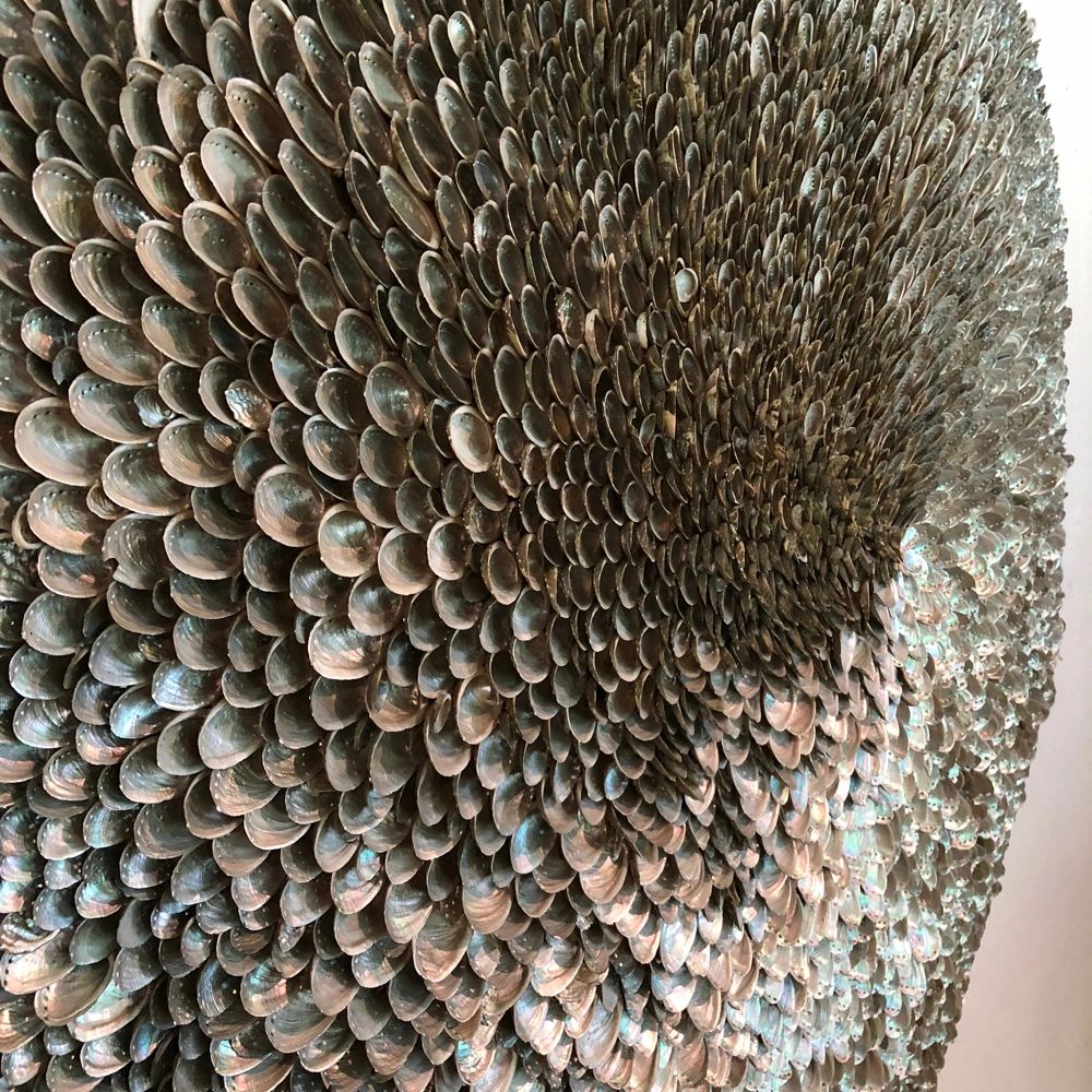 "Earradiating" is a wall sculpture made from abalone shells.