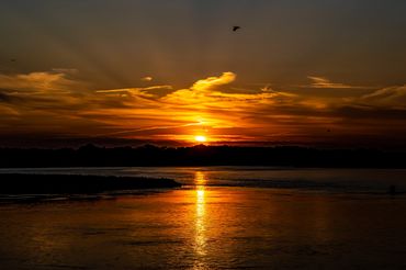 A beautiful late afternoon sunset right before dusk. Dark oranges with a slimmer of blue in the sky.