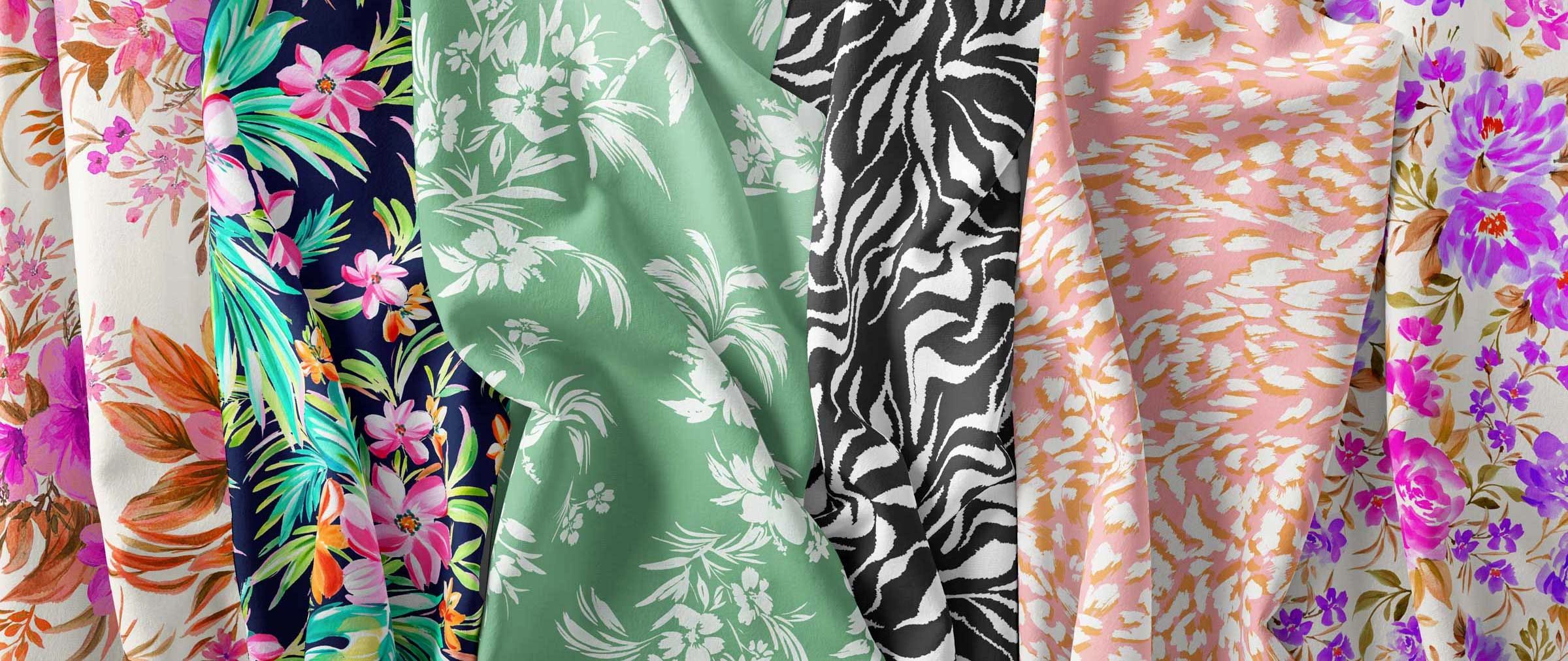 Group of silk fabrics featuring a variety of print designs; floral, tropical, animal print.