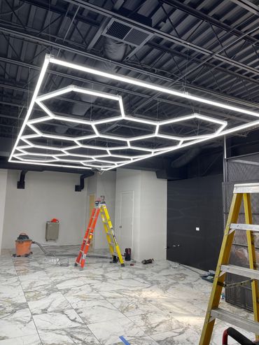 Modern hexagonal ceiling lights in an industrial room.