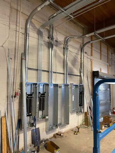 Electrical panels and conduit installation in progress.