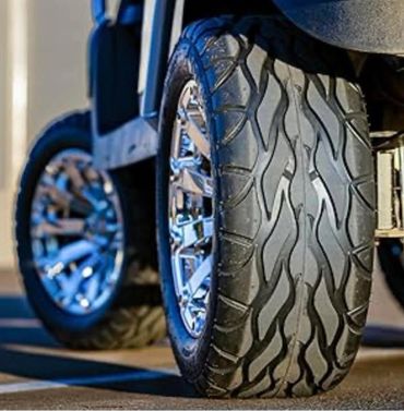 Close-up of a vehicle tire with unique tread and shiny chrome rims.
