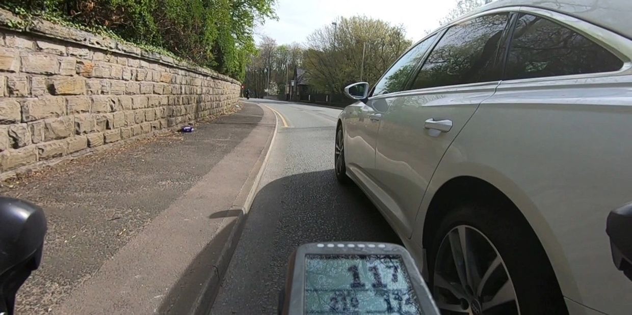 Audi car close passes cyclist on UK road Highway Code
