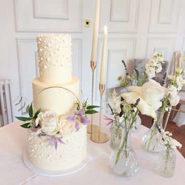 three tier ganache and pearl floral wedding cake