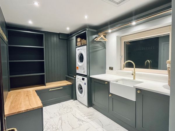 Bathroom refurbished in a more modern look with dark green accents and marble tops