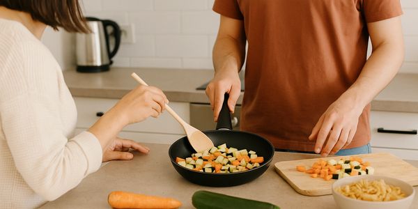 Support worker helping client with cooking skills – daily living activity at Roles & Goals