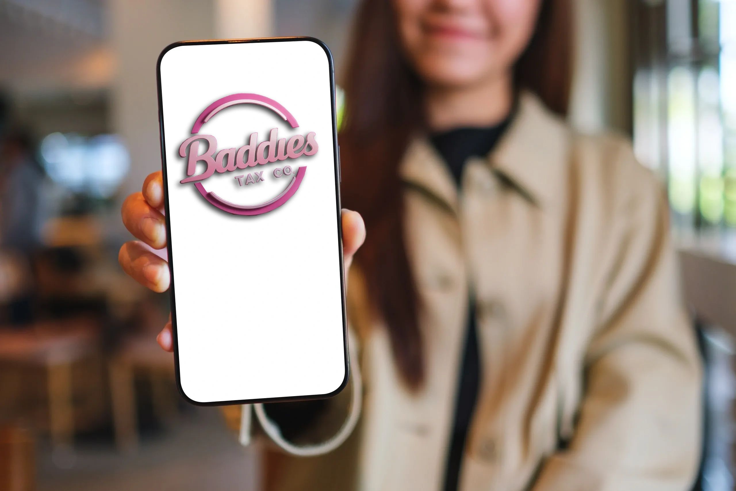 Person showing a phone screen with the Baddies Tax Co. logo.
