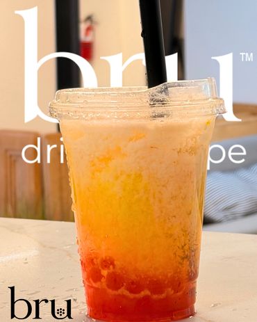 Colorful layered drink with red tapioca pearls in a clear plastic cup.