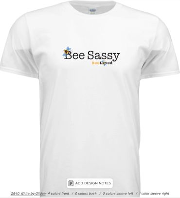 White t-shirt with the text 'Bee Sassy' and bee illustrations. BeeLoved apparel.