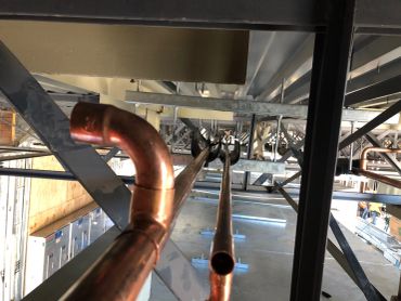 Copper piping system inside an industrial space.